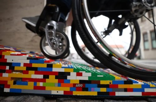 Wheelchair rolling up colourful Lego ramp